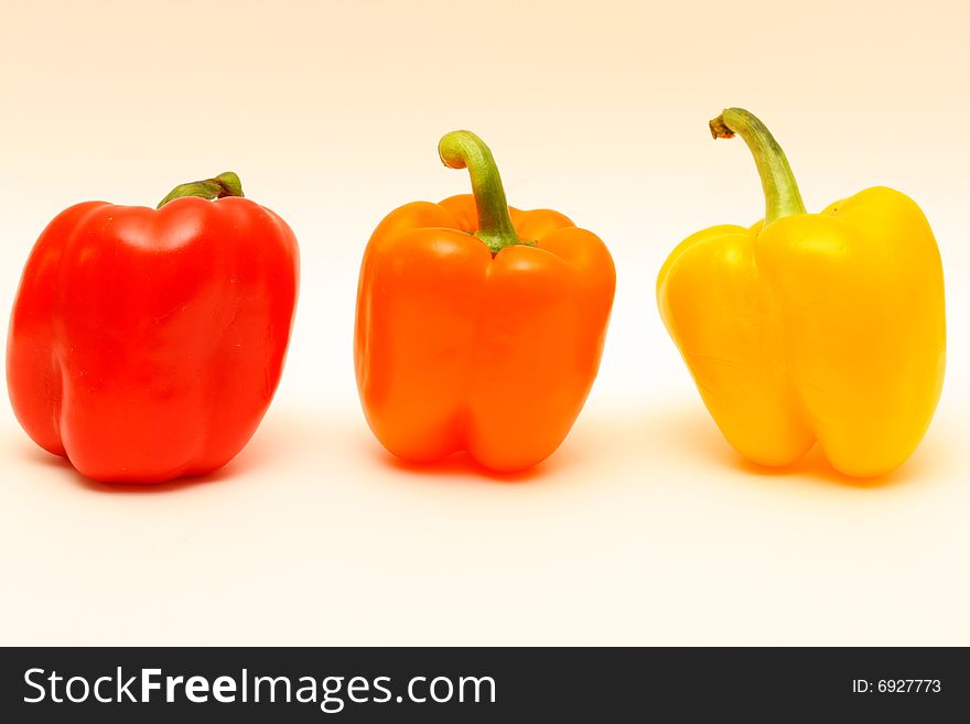 There are red, orange and yellow peppers. There are red, orange and yellow peppers