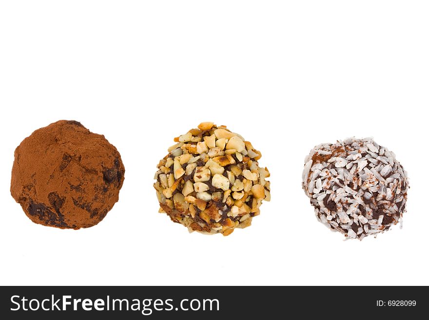 Closeup of three home made chocolate pralines isolated on white background