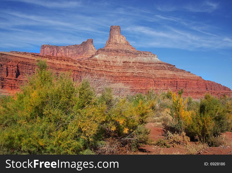 View of the red rock formations in Canyonlands National Park with blue skyï¿½s and clouds. View of the red rock formations in Canyonlands National Park with blue skyï¿½s and clouds