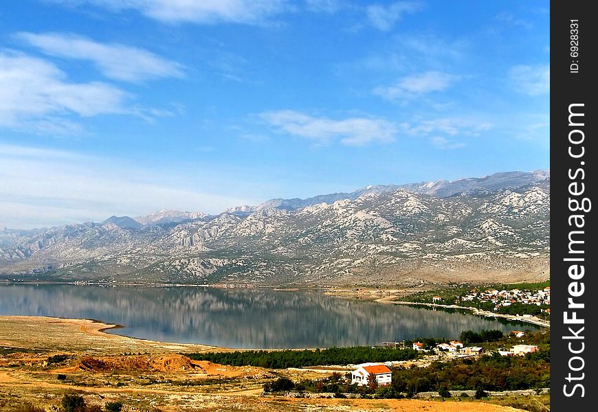 Seaside resort, sea bay under mountains and blue sky with clouds. Seaside resort, sea bay under mountains and blue sky with clouds