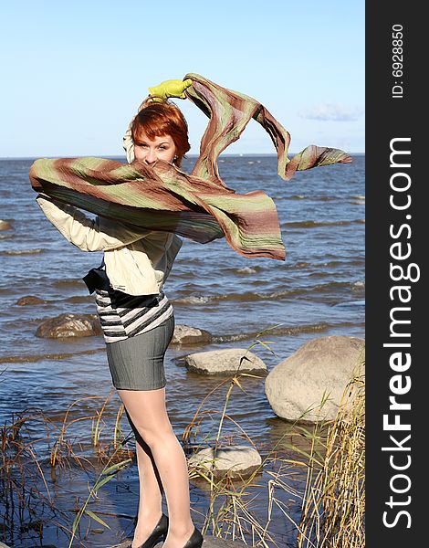 Red haired woman with scarf. Windy day.