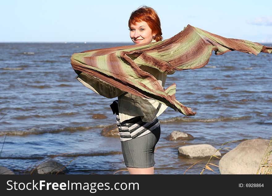 Red haired woman with scarf. Windy day.