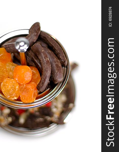 Dried fruit and chocolate in a bowl isolated on white background