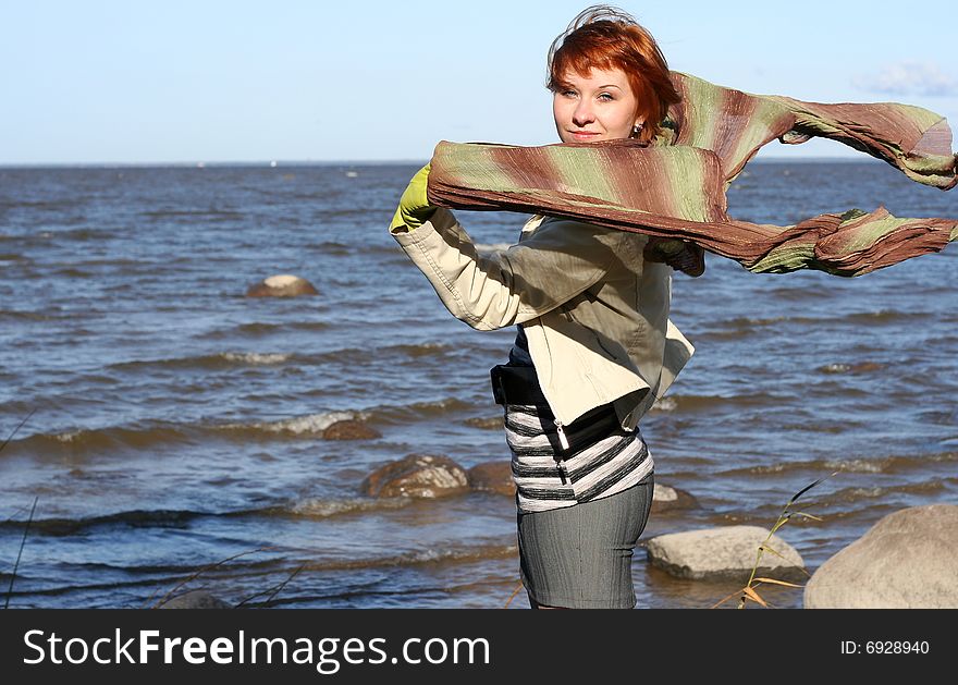 Red haired woman with scarf. Windy day.