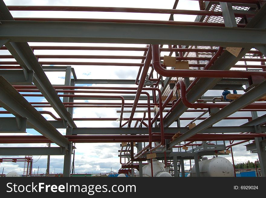 Metal pipes at blue sky. Factory buildings