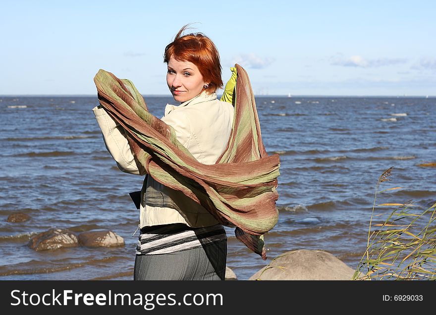Red haired woman with scarf. Windy day.
