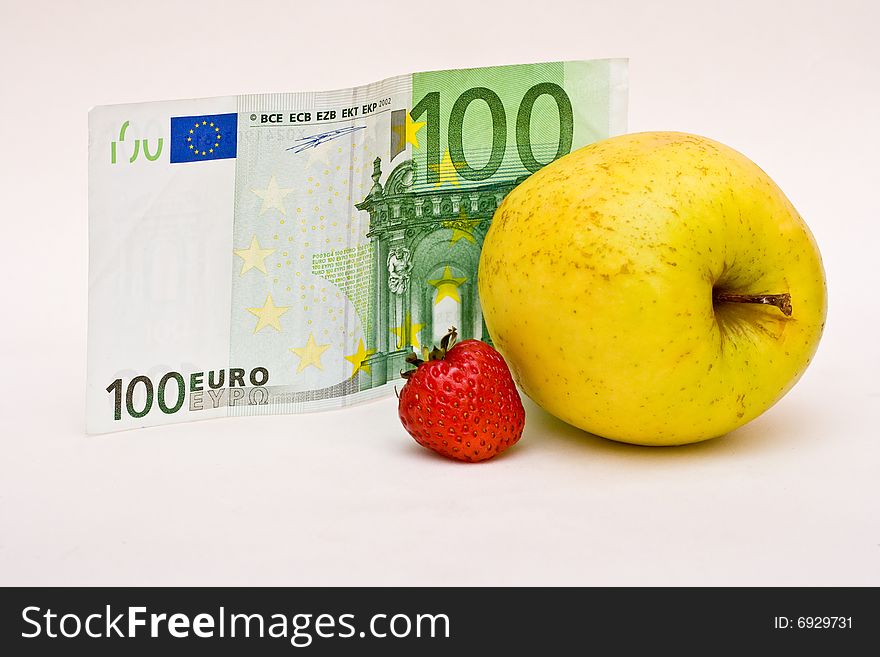 Money and fruit, apple and strawberry