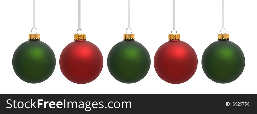 Red and green hanging Christmas ornaments on white background