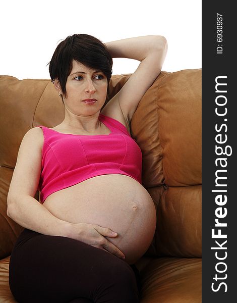 A pregnant woman sitting on a couch