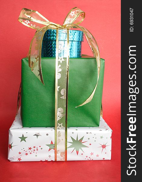 Christmas presents and golden ribbon in red background. Christmas presents and golden ribbon in red background