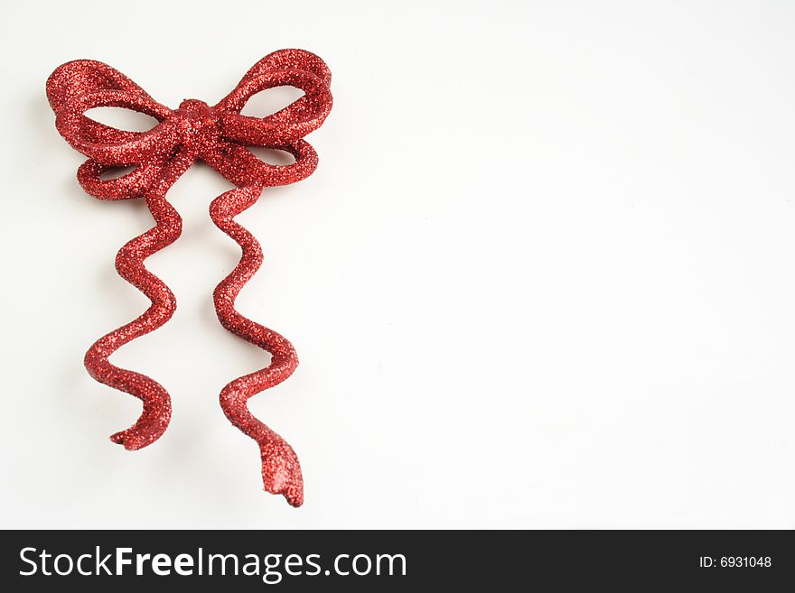 Decorative red shiny bow in white background. Decorative red shiny bow in white background