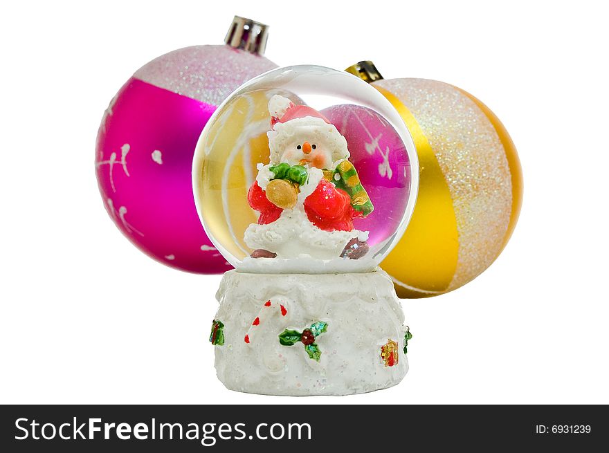 Snow globe - Christmas souvenir against two balls, isolated on white background