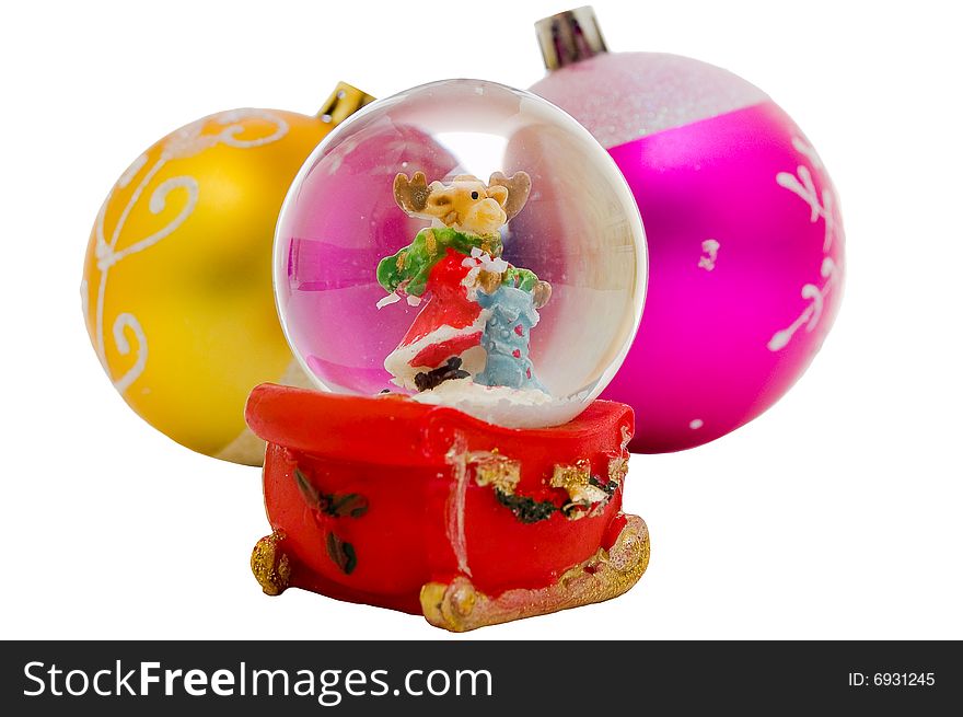 Snow globe - Christmas souvenir against two balls, isolated on white background