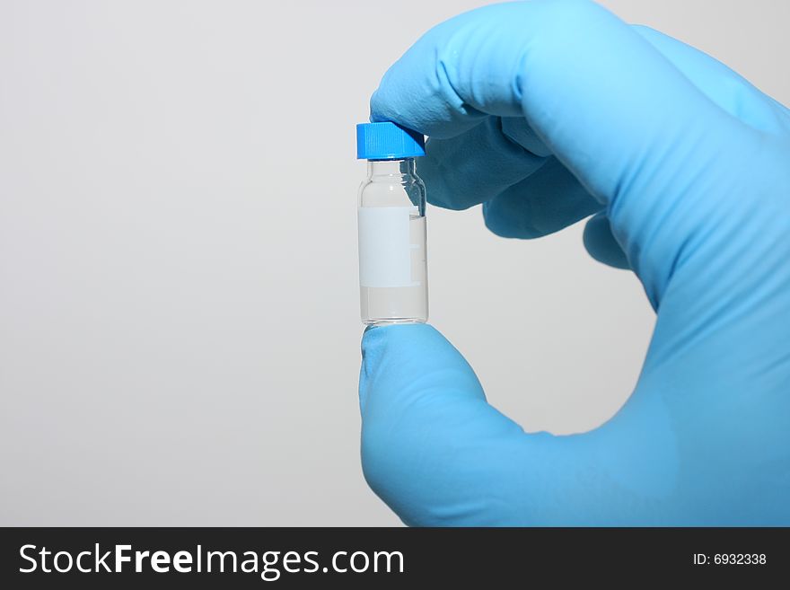 Scientist is holding small GC microvial with sample