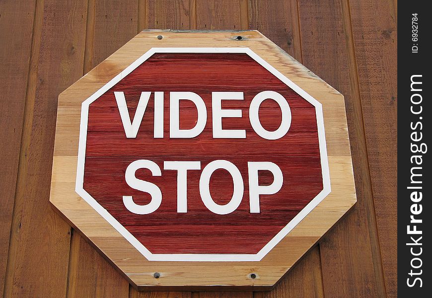 Video stop sign on a wooden wall