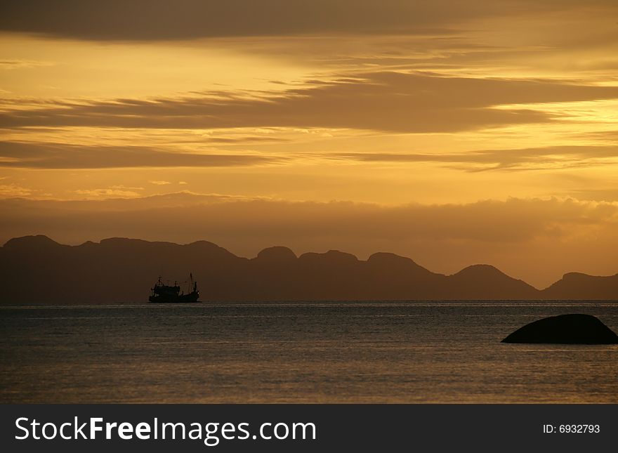 Original Thai fishing boat in the ocean on sunset. Original Thai fishing boat in the ocean on sunset