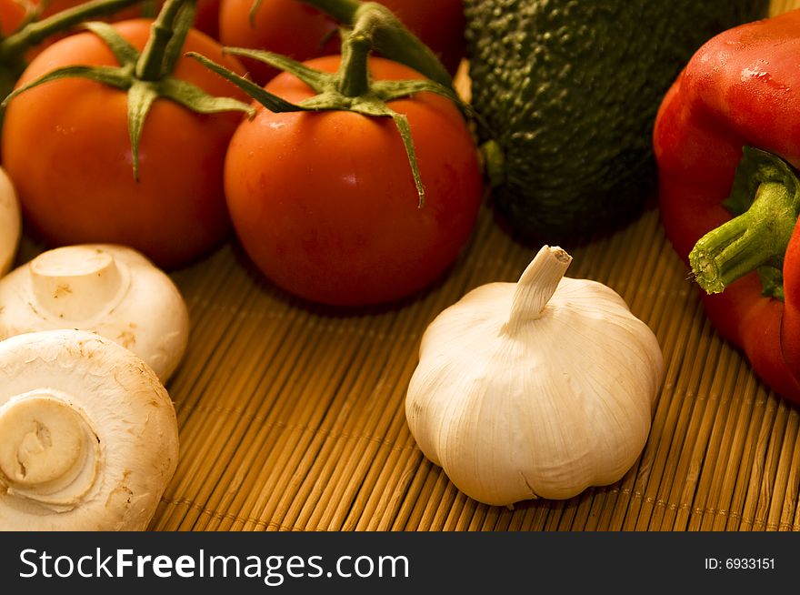 A close up view of fresh vegetables on a bench-top. A close up view of fresh vegetables on a bench-top