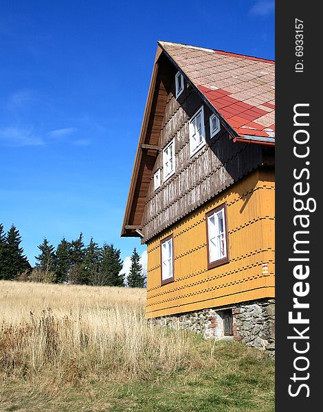 Old chalet on blue background