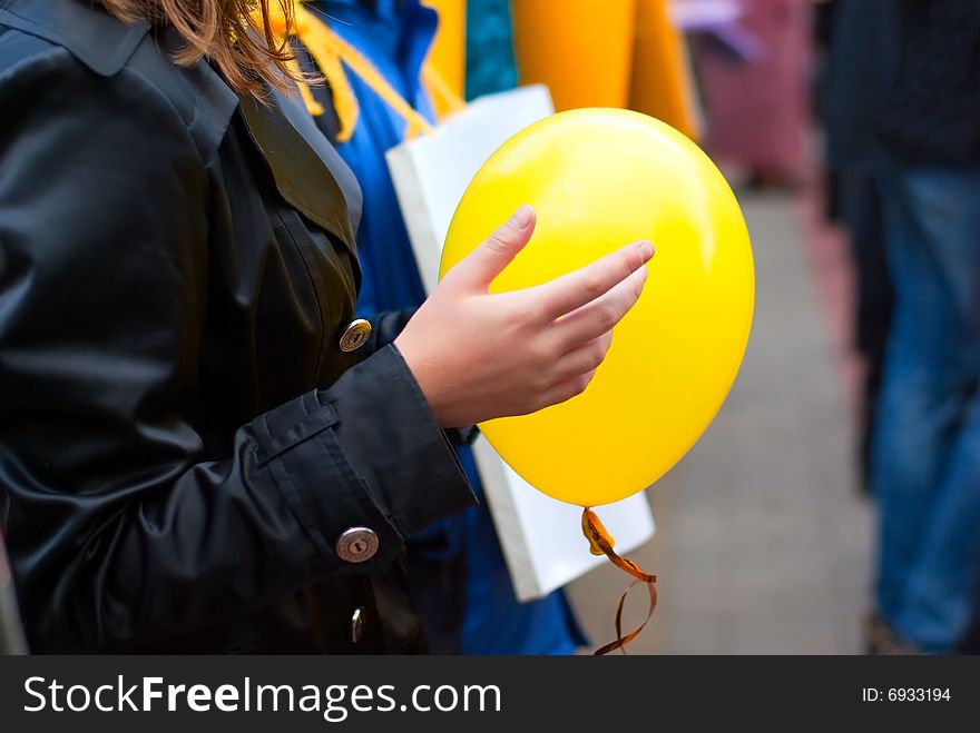 Yellow round balloon in child's hands. Yellow round balloon in child's hands