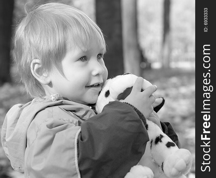 Child embraces a toy and looks afar. Child embraces a toy and looks afar