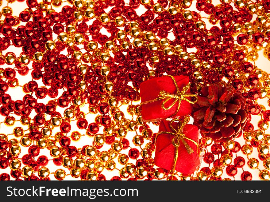 Red and golden beads with two small present boxes and cone on them. Red and golden beads with two small present boxes and cone on them