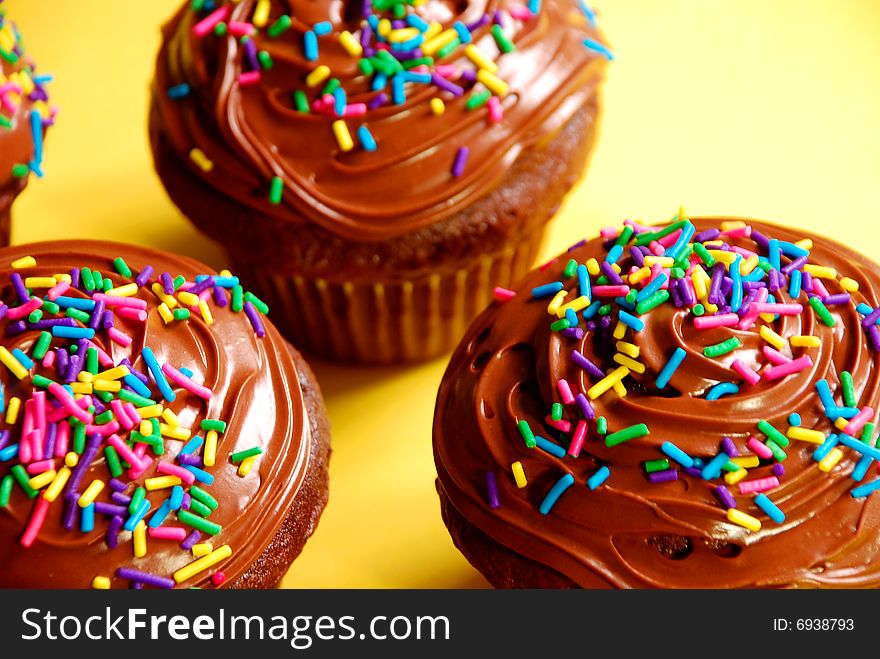 Chocolate cupcakes with frosting and sprinkles on top