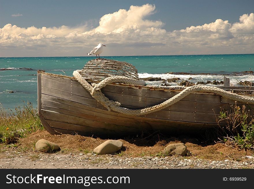 A seagull standing on a boat with ocean as background. A seagull standing on a boat with ocean as background