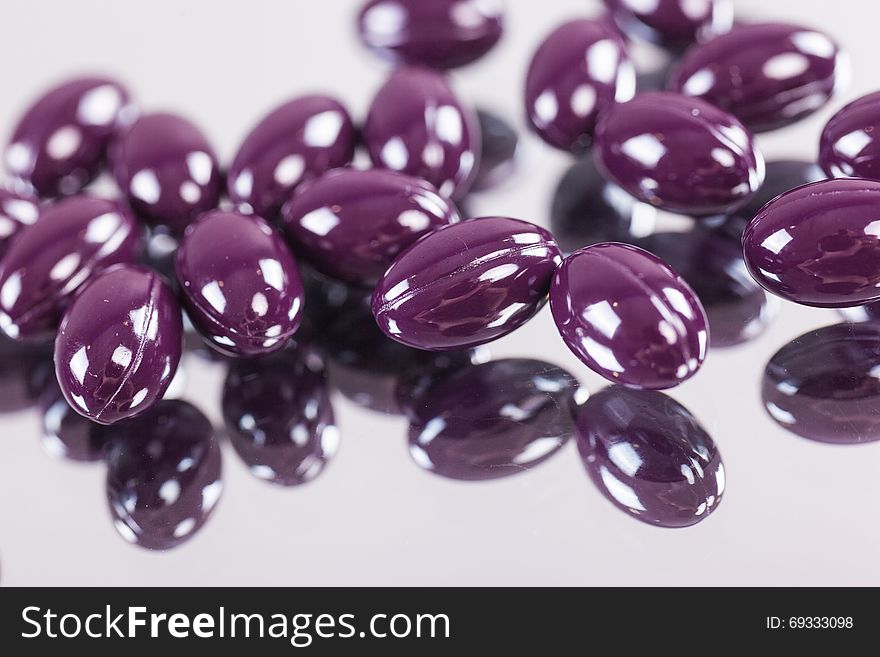 Capsules Purple Pills Closeup On Mirror Surface