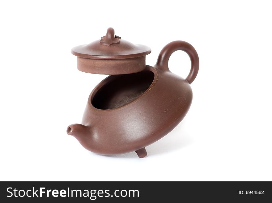 Brown ceramic chinese teapot. White background