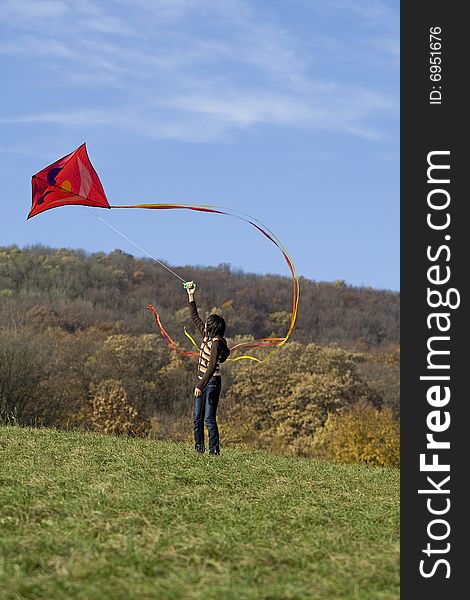 Fly a kite, teenager in fall weather in nature