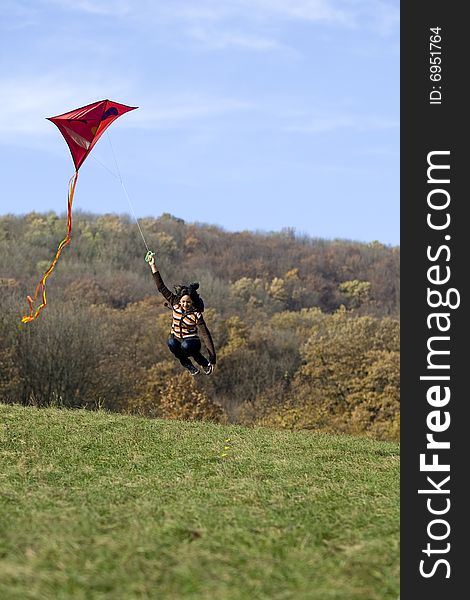 Fly a kite, teenager in fall weather in nature