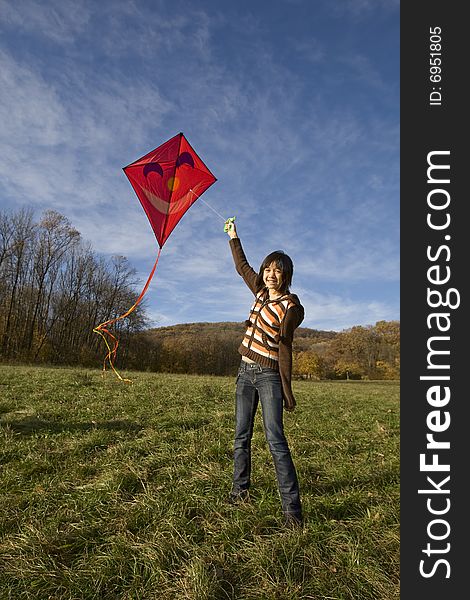 Fly a kite, teenager in fall weather in nature