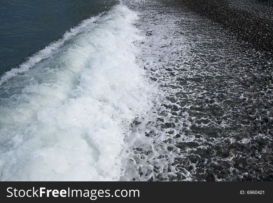 Sea coastline. Pebbles and water.