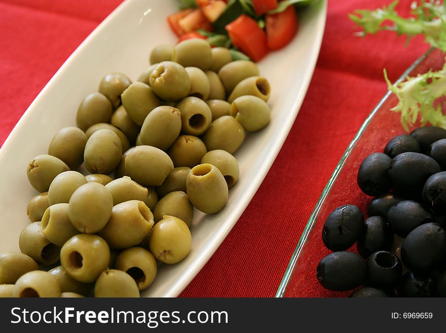 Mixed olives for aperitifs on red table. Mixed olives for aperitifs on red table