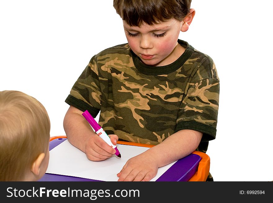 One brother showing the other how to draw on a white background. One brother showing the other how to draw on a white background
