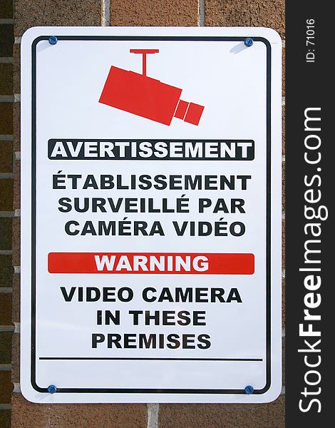 Bilingual video camera sign. Bilingual video camera sign