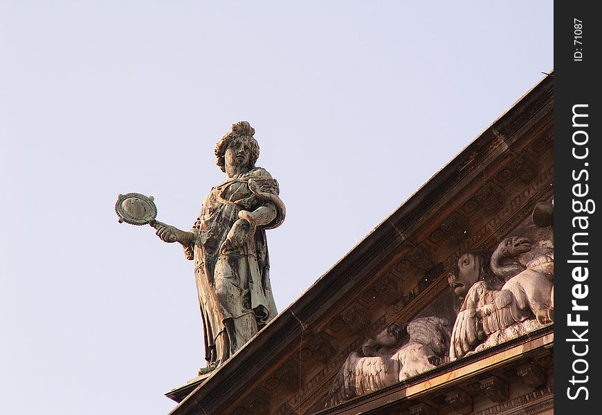 Statue on roof of royal palace, Dam square Amsterdam