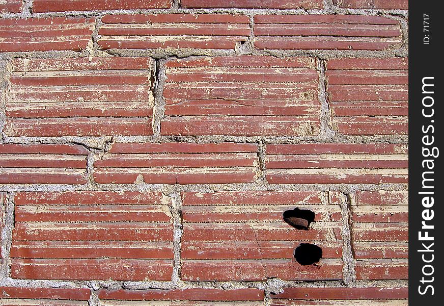 An old brick wall, with crumbling mortar and a couple of holes drilled into it. Useful for backgrounds and textures. An old brick wall, with crumbling mortar and a couple of holes drilled into it. Useful for backgrounds and textures.