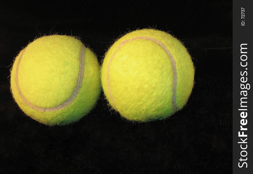 Two tennis balls on black background. Two tennis balls on black background