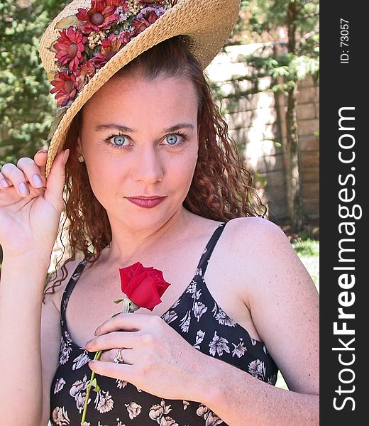 Blue eyed young lady with hat and red rose. Blue eyed young lady with hat and red rose