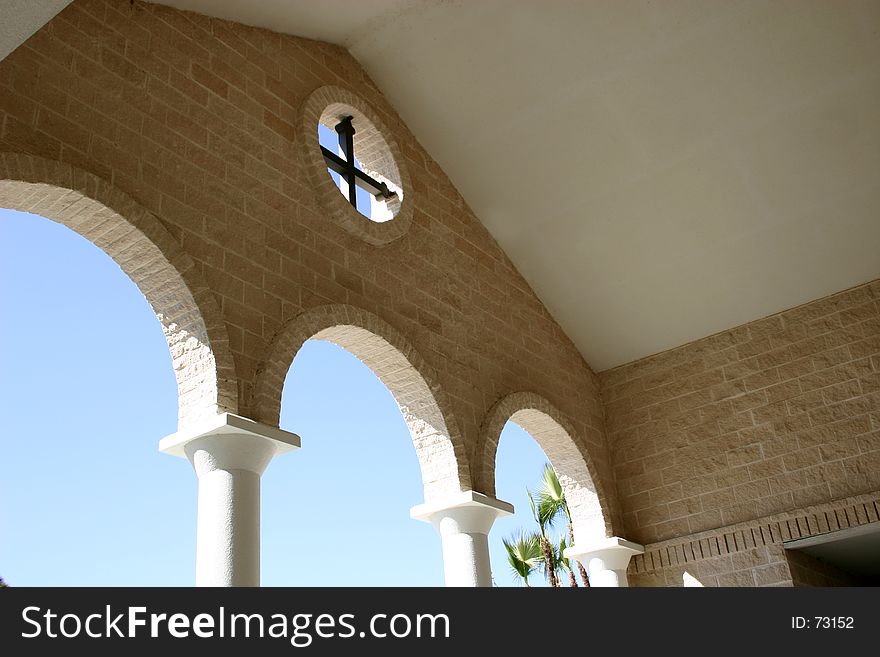 Looking out from entrance to Greek church, with view of cross and arches