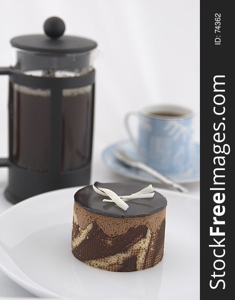 A chocolate cake, espresso up and caffetiere. A chocolate cake, espresso up and caffetiere