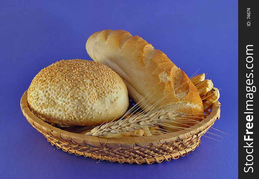 A basket of bakery products on blue background. A basket of bakery products on blue background