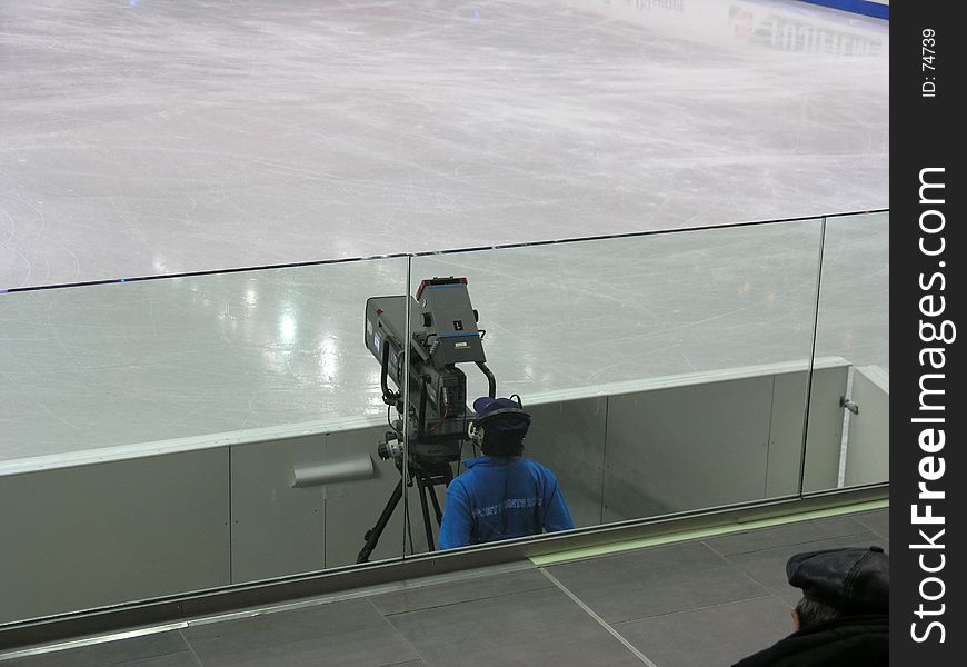 Cameraman taking a break when Zamboni is working. Cameraman taking a break when Zamboni is working