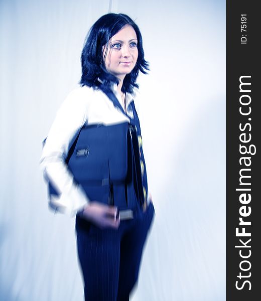 Young business woman carrying a briefcase. Motion zoom filtered added for more dynamism. Young business woman carrying a briefcase. Motion zoom filtered added for more dynamism.