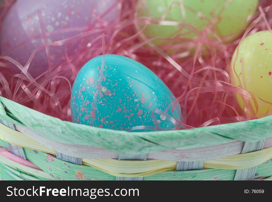 Pastel easter basket with plastic speckled eggs. Pastel easter basket with plastic speckled eggs
