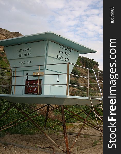 A lifeguard tower in the sand on a southern Cal. beach