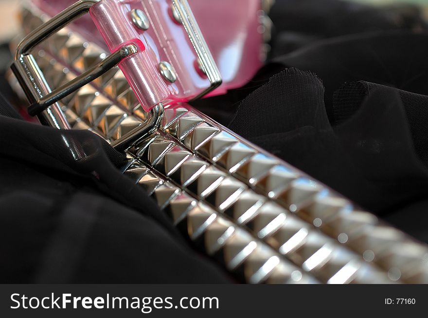 Pink studed belt. Interesting design. Line created by belt and focus is soft-sharp-soft.