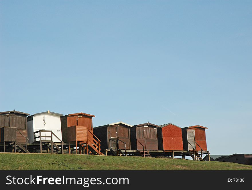 A row of beach huts on the shore at Frinton, UK. A row of beach huts on the shore at Frinton, UK
