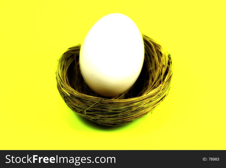 Nest and Egg on Yellow Background, Color and Blur Effect. See Portfolio For Similar Concepts. Nest and Egg on Yellow Background, Color and Blur Effect. See Portfolio For Similar Concepts